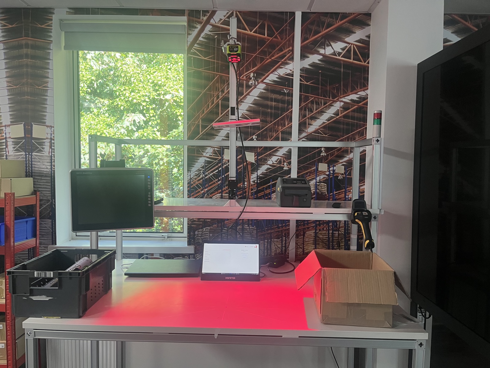 Renovotec’s physical PackingBench demo with overhead scanner, screen and label printer